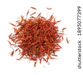 Small photo of Heap of dried safflower leaves, substitute for saffron, close up isolated on white background