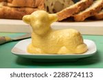 Small photo of Traditional easter butter lamb in front of slices od an easter bread close up
