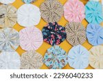 Small photo of The yo-yo handicraft is made up of several small bundles of clothes that, sewn together, give rise to flowers of different colors. interiors in rio de janeiro.