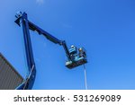 stock-photo-electric-technical-repairing-street-light-by-boom-lift-in-industrial-531269089.jpg