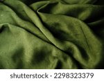 Small photo of The texture of the green velvet fabric. Textile drapery.