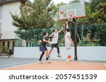Small photo of basketball player jumping with rebound position while playing