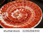 Plate with Iberian cut ham. Spanish jamon iberico (ham). Selective focus point