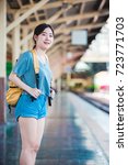 Small photo of Teen Asian girl waiting for checked baggage train platform area prepared to ready to go sightseeing by the provinces in the country, Thailand on weekends. From Bangkok to Chiang Mai