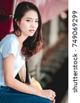 Small photo of Teen Asian girl waiting for checked baggage train platform area prepared to ready to go sightseeing by the provinces in the country, Thailand on weekends. From Bangkok to Chiang Mai