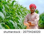 Young indian farmer at corn...
