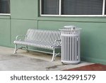 Small photo of Fort Myers, FL/USA- March 10, 2019: A horizontal image of a wire city bench and matching garbage can.