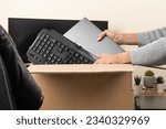 Small photo of Woman hands put old laptop and keyboard in box with old used computers and gadget devices for recycling. Planned obsolescence, e-waste, donation, electronic waste for reuse, refurbish, recycle concept