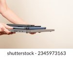 Small photo of Hands holding old laptop computer, digital tablet and smartphones. Technology, remote learning, online working, donation, charity, e-waste, electronic waste for reuse, refurbish, repair, recycle