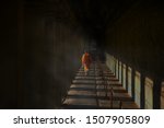 Small photo of Monk walking at Angkor Wat in Cambodia,it is the largest religious monument in the world and a World heritage listed complex. Siem Reap, Cambodia, Monk walking back and forth