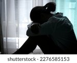 Small photo of woman sitting in the corner of the room have emotional and mental problems She has depression and stress from society and work. medical concept.