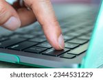 Small photo of Finger of the computer user, he presses the delete button on the computer keyboard.