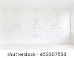 An elegant panel on a white wall made using stucco moldings