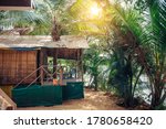 Small photo of House or hut made of palm leaves in the middle of jungle on hot tropical day. Modest dwelling in a palm grove on the bank of the river. Seclusion, asceticism, solitary life.