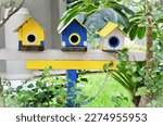Wooden birdhouses decorating the garden on a sunny day