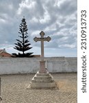 Small photo of The cross near the church in Portugal , Stone cross in Finisterre on the Camino de Santiago, Galicia, Spain. These symbols were built since the XVII century to sanctify the roads and pilgrims who walk
