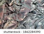 Small photo of Camouflage background texture as backdrop for russian or ussr snipers design projects. Back side of snipers camouflage jacket with many pleats on crumpled fabric