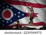 Small photo of Ohio US state flag with statue of lady justice, constitution and judge hammer on black drapery. Concept of judgement and punishment