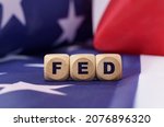 Small photo of American economy and business concept. The US flag has cubes with the inscription - FED