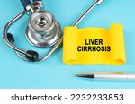 Medical concept. On the blue surface there is a stethoscope, a pen and a yellow sticker with the inscription - Liver cirrhosis