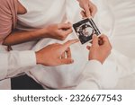 Concept Motherhood and Pregnant, Prenatal care and pregnancy. Male doctor showing ultrasound picture to pregnant woman with pregnant woman in hospital.