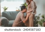 Small photo of mother, family, maternity, pregnant, woman, pregnancy, baby, motherhood, love, happiness. close up of happy pregnant newbie mother with big belly and newbie father kiss to her belly near sofa.