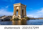 Small photo of Montpellier, France - January 16 2023 - The Chateau d’eau du Peyrou at the Bassin principal du Peyrou. The water building and pond at the promenade du Peyrou