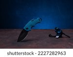 Small photo of Pocket knife and steel for making fire. Set for tourism and hike. Outdoor fire kit. Knife with bottle opener. Front view of the set.