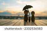Small photo of umbrella icon and family model, Security protection and health insurance. The concept of family home, protection, health care day, car insurance.
