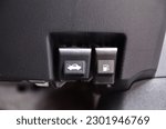 closeup shot of car fuel and bonnet release lever in a car. black interior car