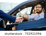 Young and handsome businessman buying used car