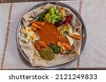 Small photo of Typical meal in Ethiopia - Beyainatu. Meaing bit of everything. Mix of vegetables and stews on injera flatbread.