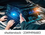 Auto mechanic checking ECU engine system with OBD2 wireless scanning tool and laptop,car information showing on screen interface,mechanic car repairing working in repair garage,Car maintenance service