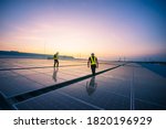 Technology solar cell, Engineer service check installation solar cell on the roof of factory on the morning. Silhouette technician inspection and repair solar cell on the roof of factory.