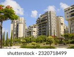 City for life. Beautiful modern urban area. Flowering trees, apartment buildings. Real estate in Israel. Scenic District
