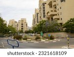 Small photo of Israel Tel Aviv Gush Dan 6 june 2023 Streets of a residential area. Modern apartment buildings, flowering trees.
