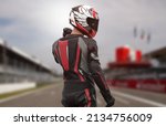 Small photo of Motorcyclist in full gear and helmet on the race track.