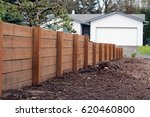 Small photo of Retaining wall from one persons house to the other, dividing the two yards. Made of pressurized wood, very sturdy and strong