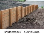 Small photo of Retaining wall from one persons house to the other, dividing the two yards. Made of pressurized wood, very sturdy and strong