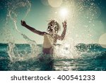 Happy Child Playing In The Sea. ...