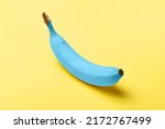Blue java banana on pastel yellow background