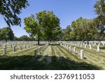 Small photo of Minneapolis, Minnesota, USA - May 27, 2023: Landscape view of soldier gravestones at Fort Snelling National Cemetery on a clear day.