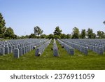 Small photo of Minneapolis, Minnesota, USA - May 27, 2023: Landscape view of soldier gravestones at Fort Snelling National Cemetery on a clear day.