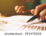 Hand woman holding pen pointing on summary report chart and calculate finance.