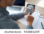 Unrecognizable businessman using calculator