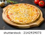 Pizza Quattro formaggi on dark concrete table