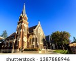 Facade of St Paul Presbyterian Church, built in 1881-82 in Gothic Revival design with a tall steeple, arched lancet windows and an impressive rose window, in Armidale, NSW, Australia