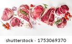 Small photo of Set of various classic, alternative raw meat, veal beef steaks - chateau mignon, t-bone, tomahawk, striploin, tenderloin, new york steak. Flat lay top view on white table background