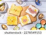 Cute funny Easter breakfast for kids. Homemade sandwiches, sandwiches in the form of symbols of the Easter holiday - Sheep, bunny rabbit, Easter egg, chicken.  top view copy space