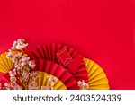 Chinese New Year theme background with copy space. Red fans, gold coins, tangerines, cherry blossoms, holiday golden branches, decor, wishes envelopes. gold dragon on red background 